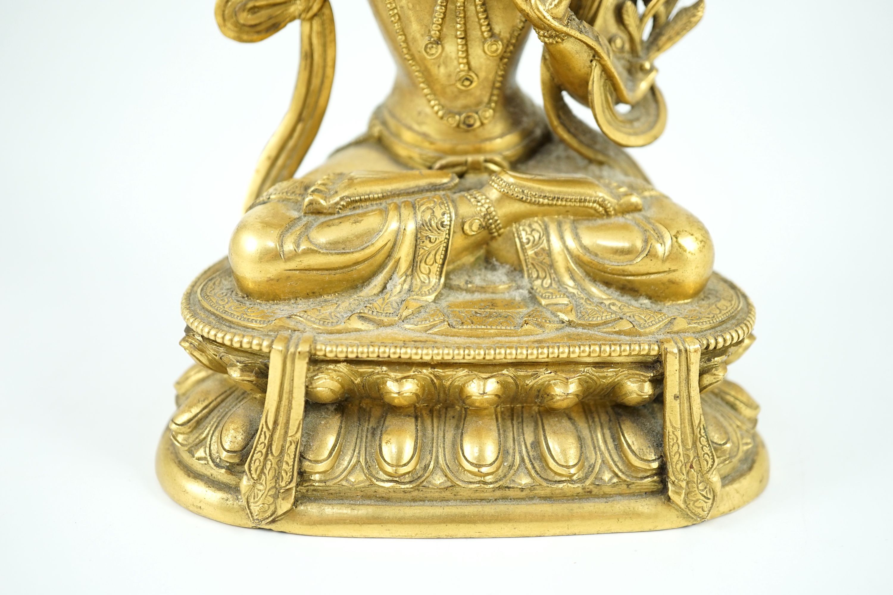 A Tibetan gilt bronze seated figure of Vajrasattva, 16.5 cm high